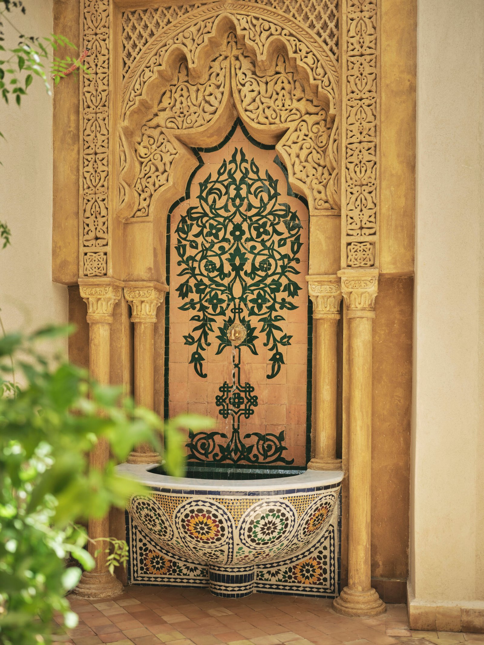 Hand-carved fountain outside room Izza